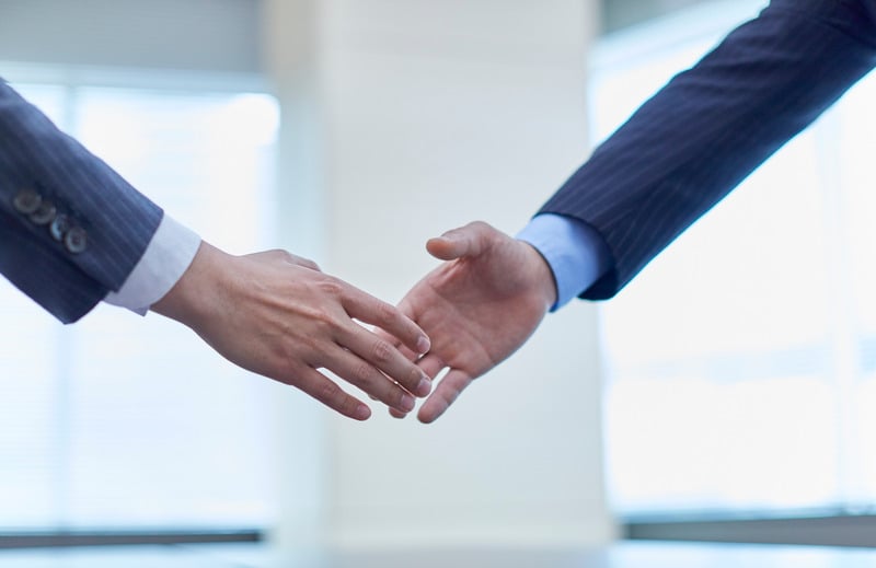 Professional handshake representing trust and ethics
